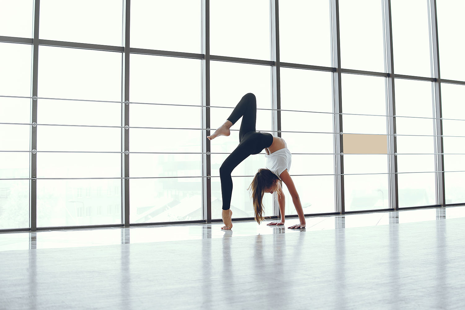 Beautiful girls in a yoga studio. Woman make exercise in a gym